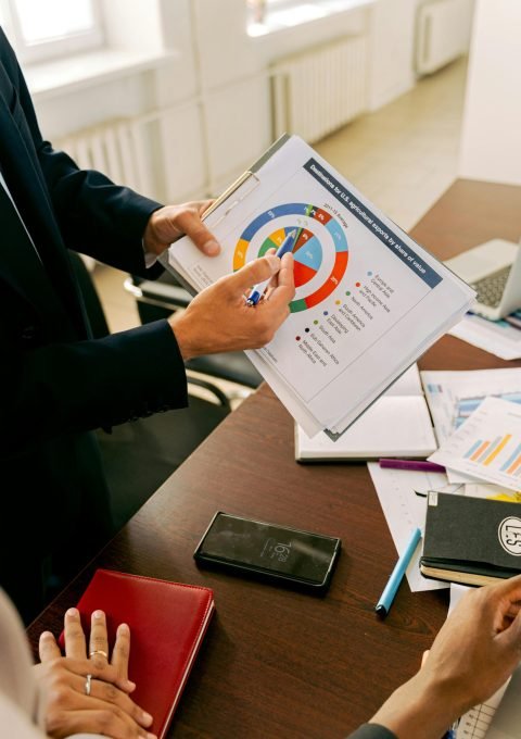 Business professionals discussing financial charts during a strategy meeting.
